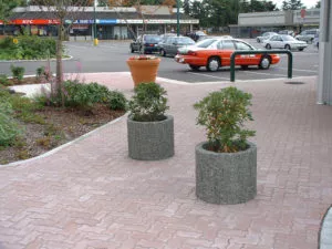 large round exposed aggregate precast concrete pedestrian control planters