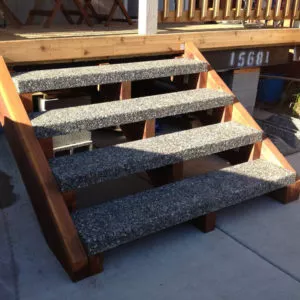 5 foot wide exposed aggregate stair treads installed with cedar stringers