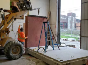 Assembling the first exterior wall panel precast concrete washroom building Surrey BC