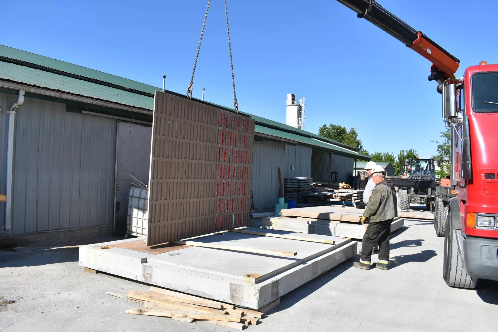 First precast concrete wall being positioned during washroom fabrication