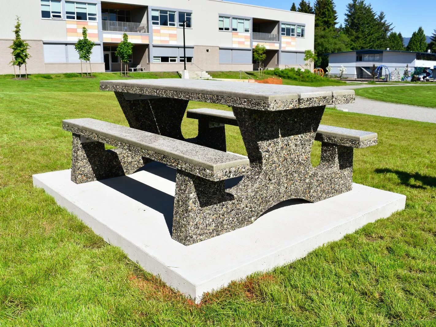 Columbia precast concrete picnic table on a concrete slab for school and public space use