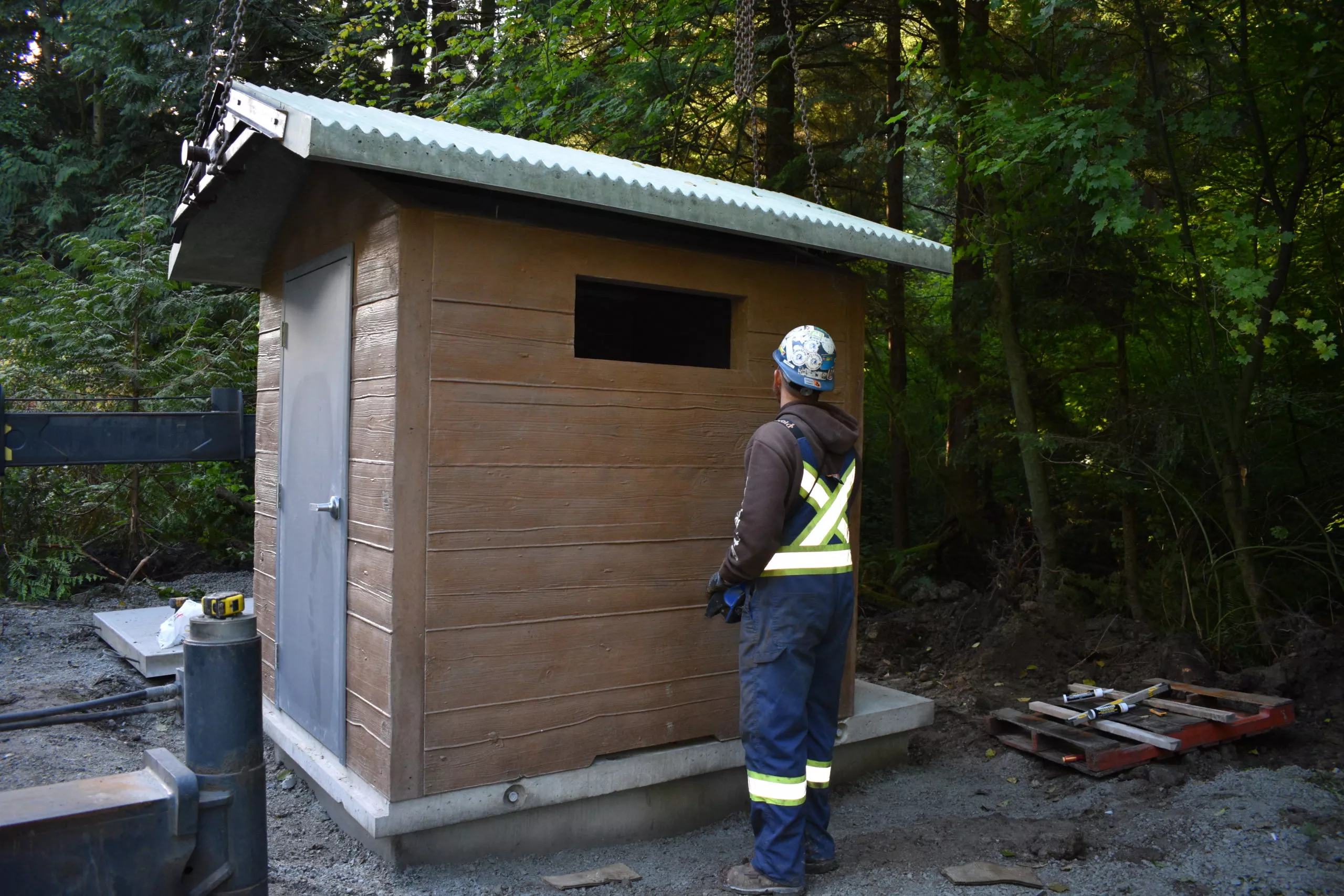 Precast concrete pit toilet being installed on site